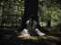 Girl sitting in front of tree