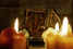 Framed picture of Goddess Lakshmi behind burning candles