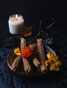 Plate of churros with dried peppers and burning candle