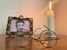 Great grandfather’s glasses in front of portrait and burning candle